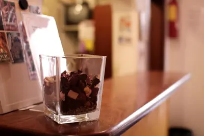a glass vase filled with rocks sitting on a counter at Hostel New York in Barcelona