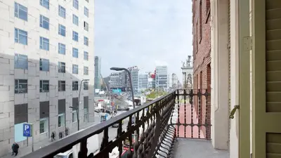 a balcony of a building with a view of a city at AB Montjuic in Barcelona