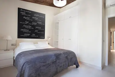 a bedroom with a bed with a chalkboard on the wall at AB Poble Nou Venero in Barcelona