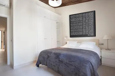 a bedroom with a bed with a black board on the wall at AB Poble Nou Venero in Barcelona