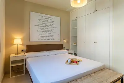 a bedroom with a white bed with a box on it at AB Poble Nou Venero in Barcelona