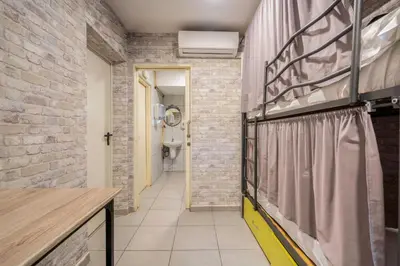 a bathroom with a toilet in a brick wall at Casa Barcelo Camp Nou Barcelona in Hospitalet de Llobregat