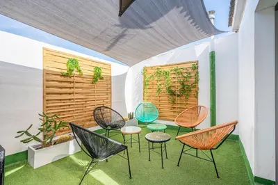 a group of chairs and tables on a patio at Casa Barcelo Camp Nou Barcelona in Hospitalet de Llobregat