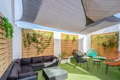 a living room with a couch and a table and chairs at Casa Barcelo Camp Nou Barcelona in Hospitalet de Llobregat