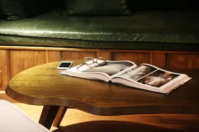 a book on a table with glasses and a cell phone at Ofelias Hotel 4Sup in Barcelona