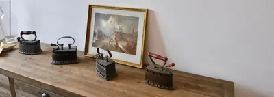a wooden table with a painting on a wall at Villa Bianca in Sitges