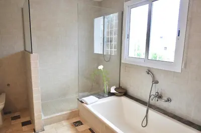 a bathroom with a bath tub and a window at Villa Bianca in Sitges