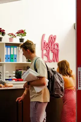a man and a woman standing in a hotel room at HelloBCN Youth Hostel Barcelona in Barcelona