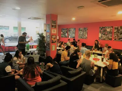 a group of people sitting in a room at HelloBCN Youth Hostel Barcelona in Barcelona