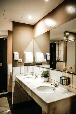a bathroom with two sinks and a large mirror at HelloBCN Youth Hostel Barcelona in Barcelona