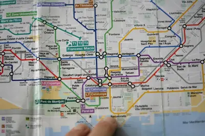 a person is looking at a subway map at HelloBCN Youth Hostel Barcelona in Barcelona