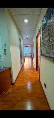 an empty hallway of an office building with a wooden floor at Hostal Madrazo in Barcelona