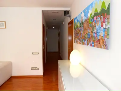 a living room with a painting on the wall at Hostal Madrazo in Barcelona