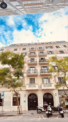 a large building with motorcycles parked in front of it at Hostal Madrazo in Barcelona