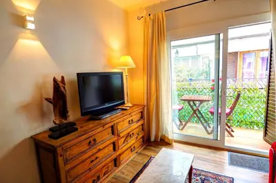 a living room with a flat screen tv on a dresser at Olivia Apartment by Hello Homes Sitges in Sitges