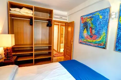a bedroom with a bed and a painting on the wall at Olivia Apartment by Hello Homes Sitges in Sitges