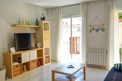 a living room with a tv and a coffee table at Lucy Apartment by Hello Homes Sitges in Sitges