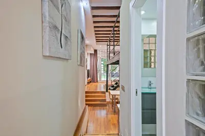a hallway of a home with white walls and wood floors at Alcam Loft Grassot in Barcelona