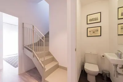 a bathroom with a staircase and a toilet and a sink at Petit Luxe Dúplex in Terrassa