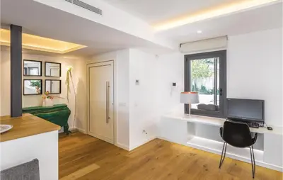 a room with a desk with a television and a window at Stunning Home In Alella With Wifi in Alella