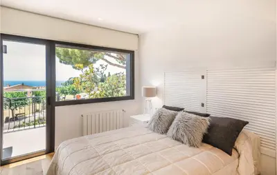 a bedroom with a large bed with a large window at Stunning Home In Alella With Wifi in Alella