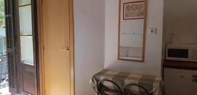 a room with a table with two chairs and a microwave at Barcelona Rooms 294 in Barcelona