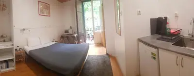 a room with a bed in the middle of a kitchen at Barcelona Rooms 294 in Barcelona