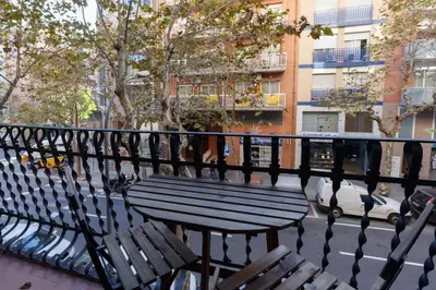 a bench sitting on a balcony next to a street at Barcelona Rooms 294 in Barcelona