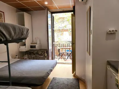 a bedroom with a bunk bed and a door to a balcony at Barcelona Rooms 294 in Barcelona