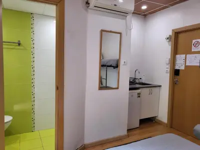a bathroom with a toilet and a table and a mirror at Barcelona Rooms 294 in Barcelona