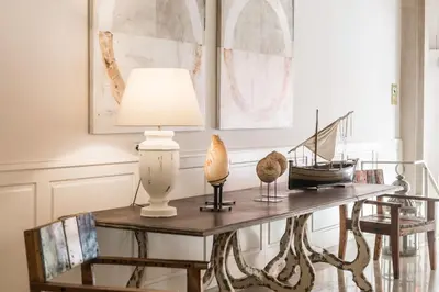 a table with a lamp and other items on it at Hotel Medium Sitges Park in Sitges