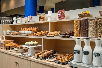 a bakery with many different types of pastries on shelves at Hotel Medium Sitges Park in Sitges