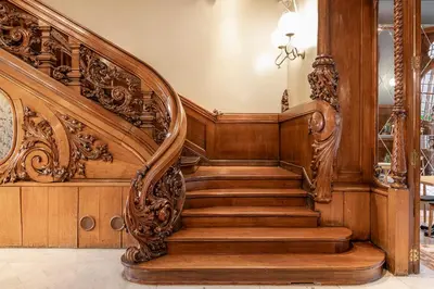 an ornate wooden staircase in a home with wooden walls at El Palauet Modernist Suites Barcelona in Barcelona