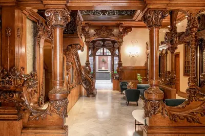 a large room with wooden walls and wood columns at El Palauet Modernist Suites Barcelona in Barcelona