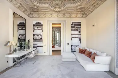 a living room with a couch and a table at El Palauet Modernist Suites Barcelona in Barcelona