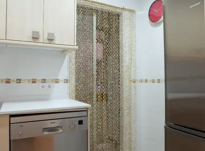 a kitchen with a shower with a shower curtain at Avinguda Gaudi Apartment in Barcelona
