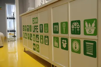 a wall with green and white stickers on it at Sleep Green - Certified Eco Youth Hostel in Barcelona