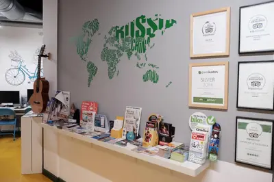 a display counter with a world map on the wall at Sleep Green - Certified Eco Youth Hostel in Barcelona