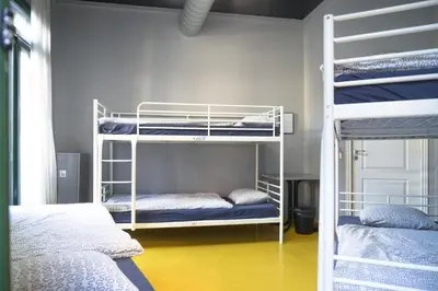 a room with two bunk beds and a room with at Sleep Green - Certified Eco Youth Hostel in Barcelona
