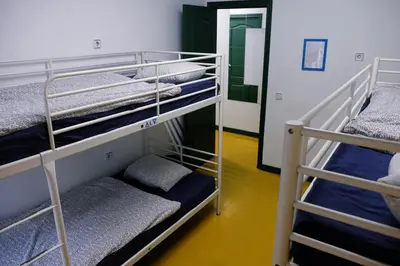 a room with two bunk beds and a mirror at Sleep Green - Certified Eco Youth Hostel in Barcelona
