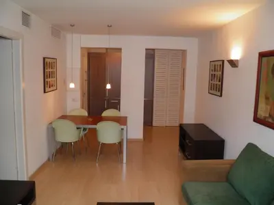 a living room with a table and chairs and a couch at Apartaments Sant Jordi Fontanella in Barcelona