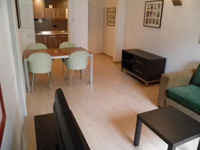 a living room with a table and chairs and a couch at Apartaments Sant Jordi Fontanella in Barcelona