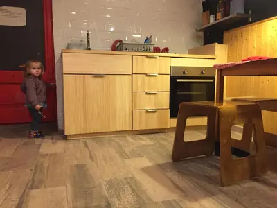 a little boy standing in a kitchen with a counter at Buba House - Women Only Hostel in Barcelona