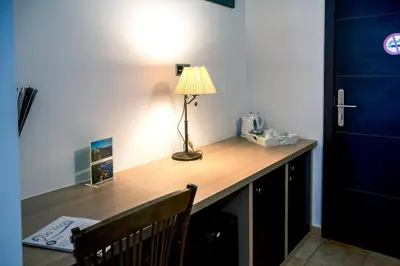 a desk in a room with a lamp on it at Sa Voga Hotel & Spa in Arenys de Mar
