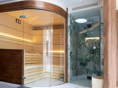a bathroom with a shower and a glass door at Sa Voga Hotel & Spa in Arenys de Mar