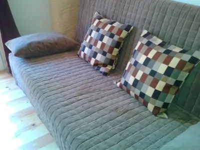 a couch with two pillows on top of it at Lovely double apartment - Sagrada Familia - Air conditioning in Barcelona