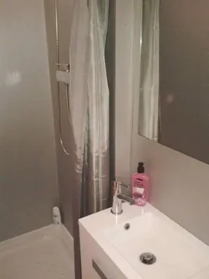 a bathroom with a sink and a shower with a mirror at Lovely double apartment - Sagrada Familia - Air conditioning in Barcelona