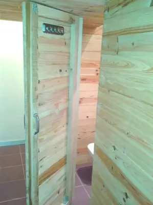 a wooden bathroom with a toilet and a wooden wall at Lovely double apartment - Sagrada Familia - Air conditioning in Barcelona