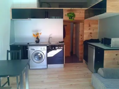a kitchen with a stove and a washing machine at Lovely double apartment - Sagrada Familia - Air conditioning in Barcelona