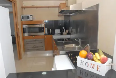 a kitchen with a bowl of fruit on a counter at Apartamento Montroig 3 Ático in Sitges